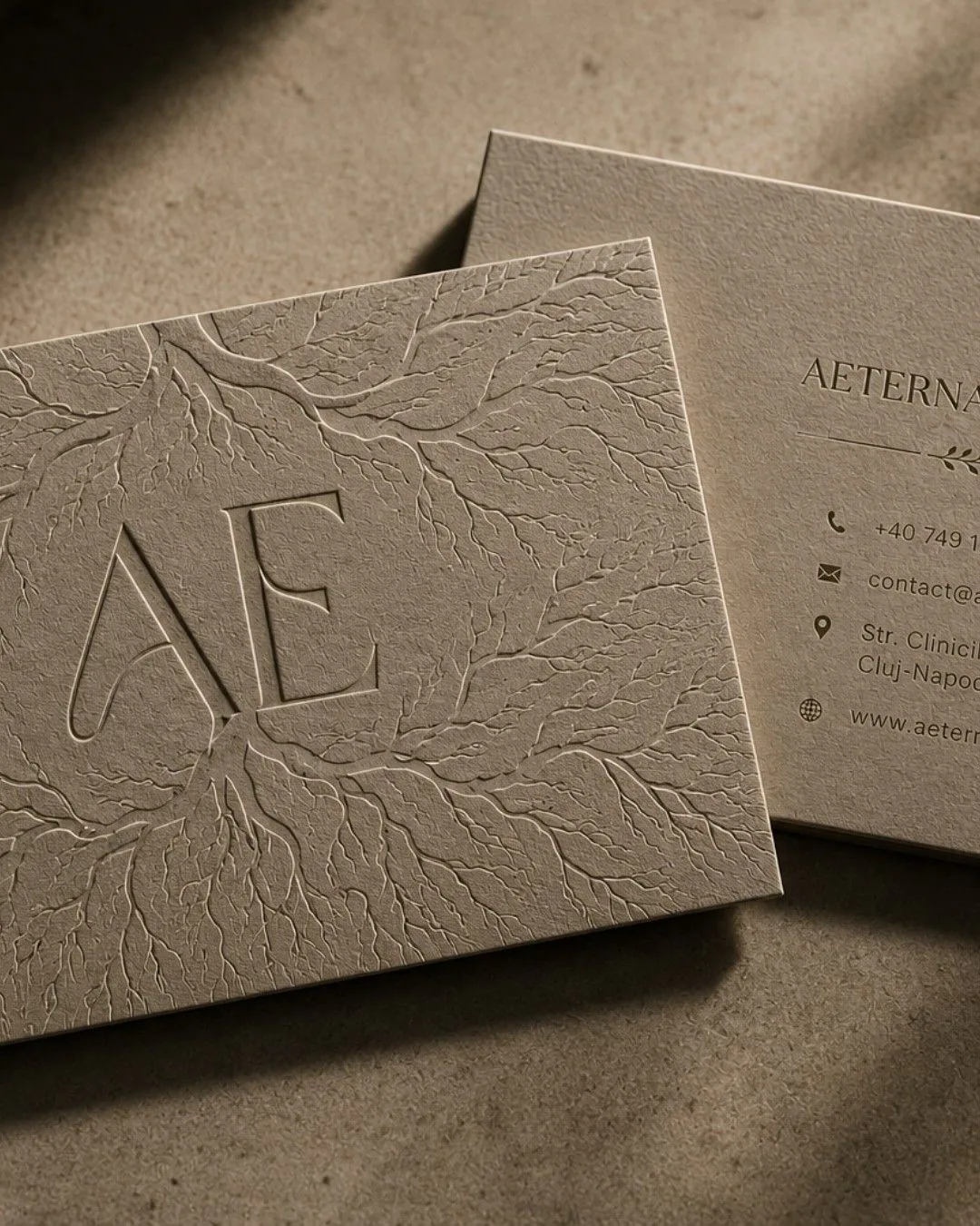 Aeterna Clinic business card with embossed AE monogram